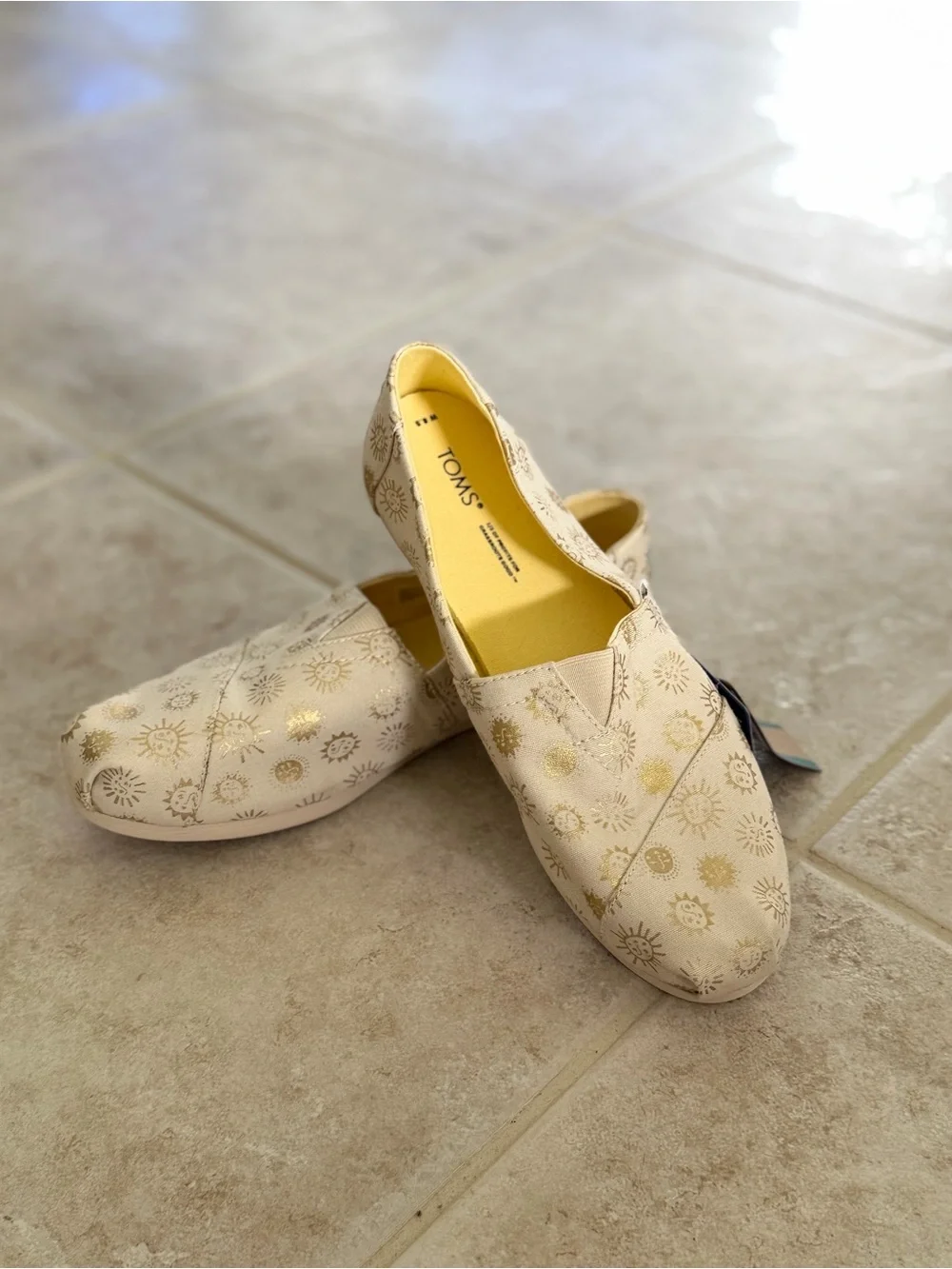 TOMS Beige Canvas Slip-Ons with Metallic Gold Sun Motif